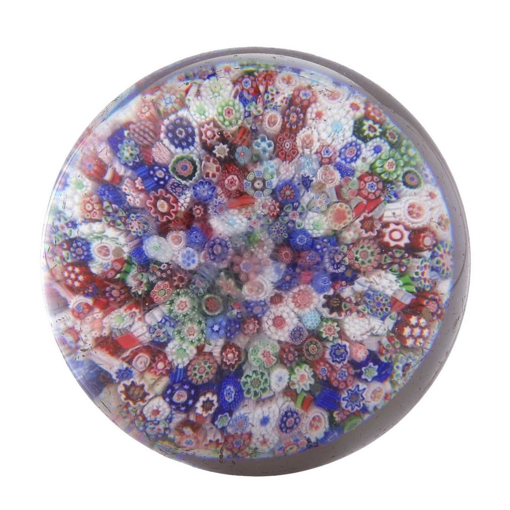 A Baccarat millefiori glass paperweight, circa 1850, French,: A Baccarat millefiori glass paperweight, circa 1850, French, formed of close-packed complex murrine canes (7.8cm diameter, 5.1cm high)