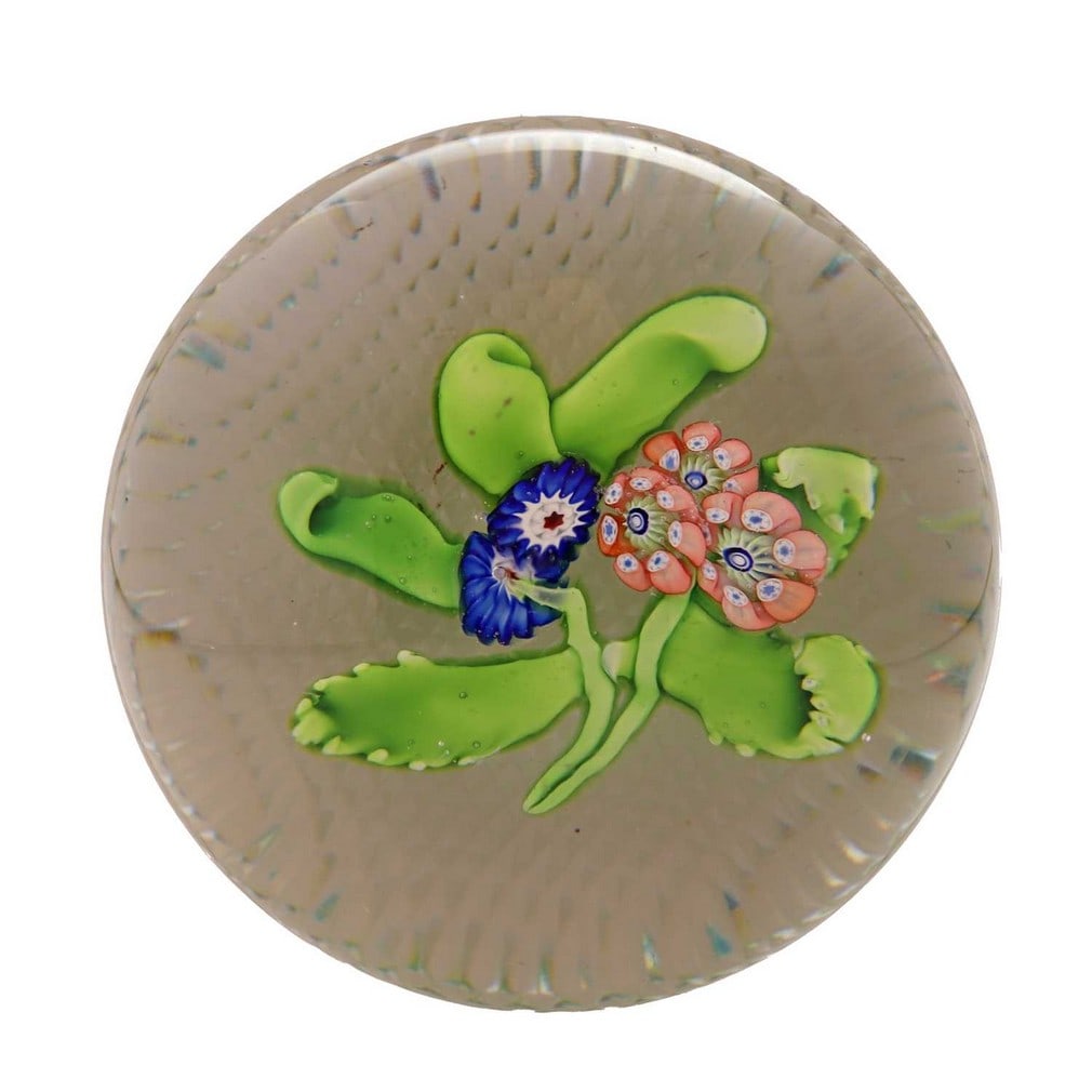 A St Louis glass bouquet paperweight, circa 1850, French,: A St Louis glass bouquet paperweight, circa 1850, French, centred with a floral spray over an amber-flashed and diamond-cut base (8.1cm diameter, 4.9cm high) Condition Report: Small bruises to the upp