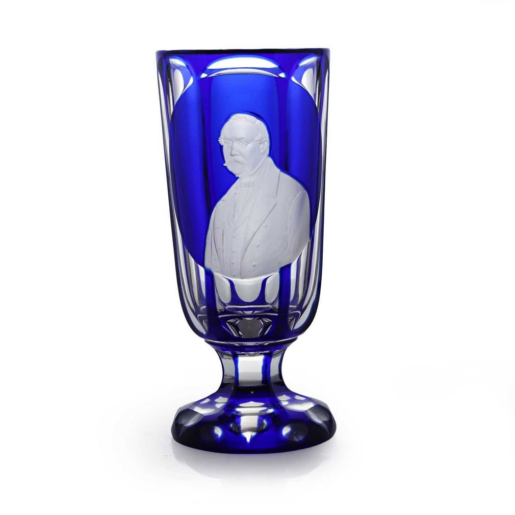 An engraved glass portrait vase, circa 1850, Bohemian,: An engraved glass portrait vase, circa 1850, Bohemian, cased, cut, and engraved with a shoulder-length portrait of a gentleman, with a viewing lens to the reverse (6.7cm diameter, 15.2cm high) Provena