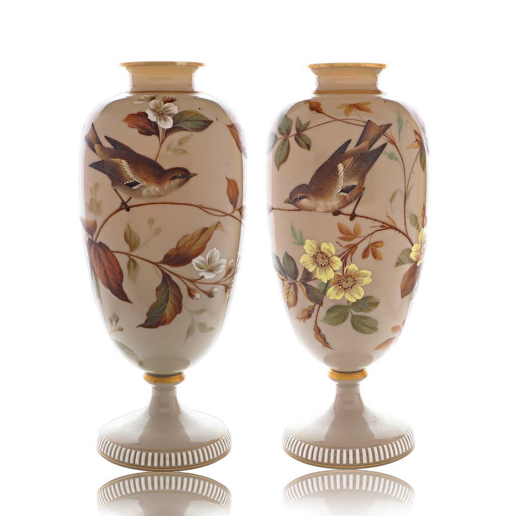 A pair of opaline glass vases, 19th century, possibly French,: A pair of opaline glass vases, 19th century, possibly French, each of footed ovoid form, enamelled with birds amongst flowers within a gilt border (33cm high) (2)