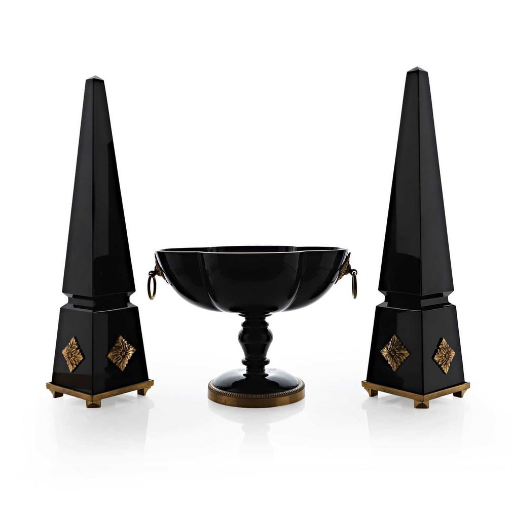 A group of Baccarat glass items, late 20th century, French,: A group of Baccarat glass items, late 20th century, French, comprising a pair of obelisks, with applied gilt-metal mounts, and a matched pedestal bowl, of lobed form, all in a deep 'black' glass, acid
