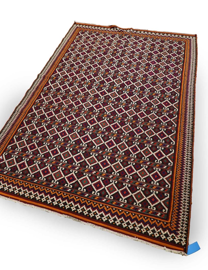 A South West Persian Qashqai kilim,: A South West Persian Qashqai kilim, The field woven with a repeating lattice of hooked lozenge motifs enclosing stepped cruciform elements, arranged in horizontal bands across a deep indigo ground,