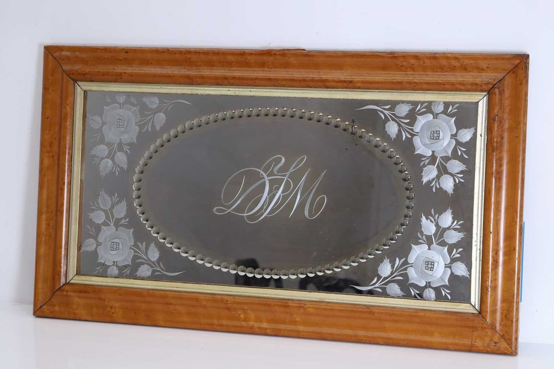 A birds eye maple framed sorcerer’s mirror, early 20th century,: A birds eye maple framed sorcerer’s mirror, early 20th century, monogrammed to the central field 'DIM', with acid-etched rose to each corner 40 x 71cm Condition Report: The frame slightly