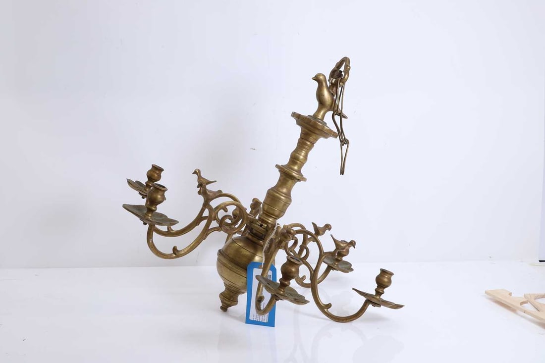 A Dutch six branch chandelier, 19th/20th century,: A Dutch six branch chandelier, 19th/20th century, the central column surmounted with a bird, each scrolled branch mounted with a bird, with a shaped drip pan, drilled 56cm high, 62cm diameter 