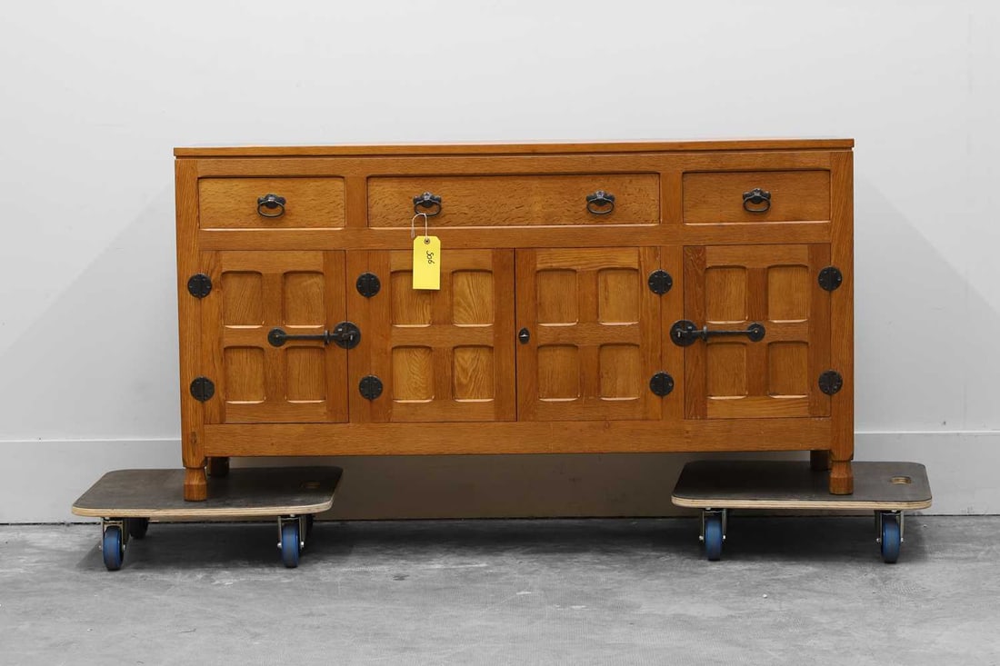 Derek 'Lizardman' Slater (b.1945), late 20th century,: Derek 'Lizardman' Slater (b.1945), late 20th century, an oak sideboard, with an adzed top, with three drawers over a pair of panelled cupboards, flanked with single doors 153cm wide 42.5cm deep