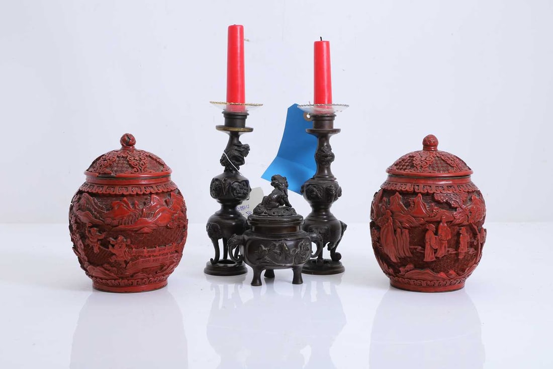 A pair of Chinese cinnabar lacquer and enamelled vases and covers, circa 1900,: A pair of Chinese cinnabar lacquer and enamelled vases and covers, circa 1900, decorated in relief with figures in a mountainous landscape amongst pine trees and cranes, together with a bronze tripod