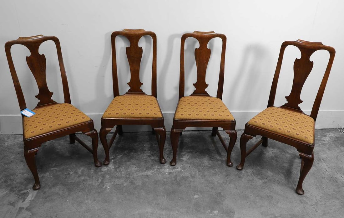 A set of four George II walnut dining chairs, circa 1740,: A set of four George II walnut dining chairs, circa 1740, with a shaped back splat and cabriole legs, with upholstered drop in seat 53cm wide, 51cm deep, 102cm high 4