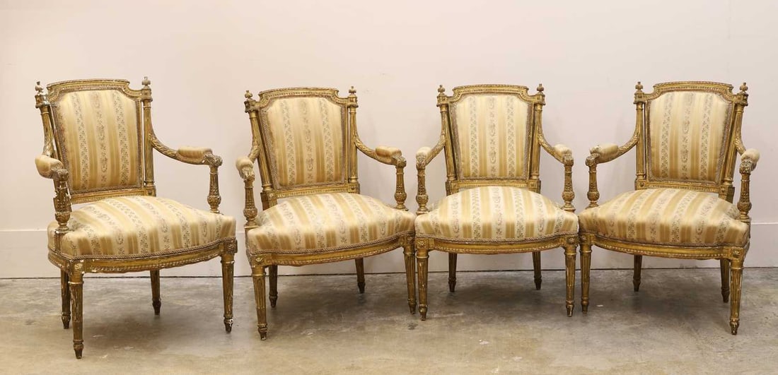 A set of four Louis XVI style fauteuils, early 20th century, French,: A set of four Louis XVI style fauteuils, early 20th century, French, with striped silk upholstery, raised on short fluted gilded supports 63cm wide, 53cm deep, 90cm high 4 Condition Report: Some
