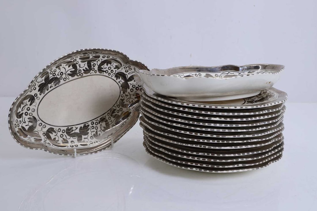 A dessert service, Wedgwood,: A dessert service, Wedgwood, with floral lustreware design, comprising of twelve, and two lozenge shaped serving dishes Plates, 23.2cm diameter; Serving dishes, 27cm wide 14 Condition Report: