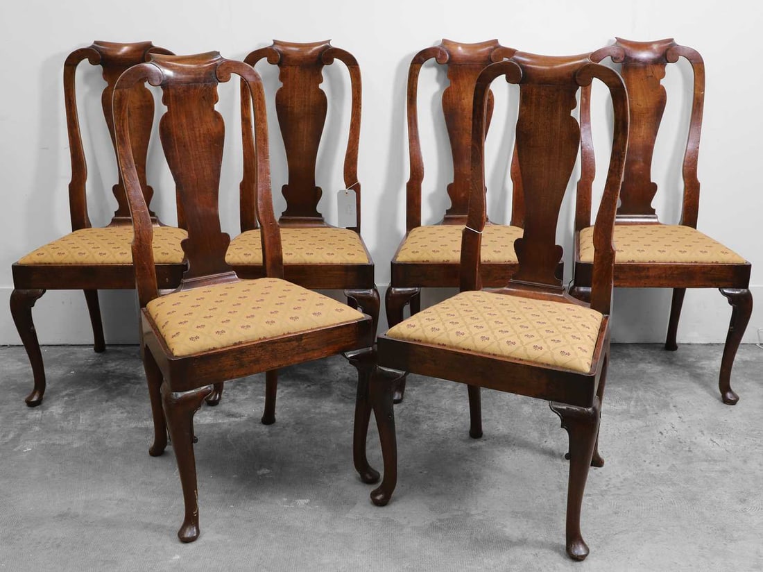 A set of six George II mahogany dining chairs, circa 1740,: A set of six George II mahogany dining chairs, circa 1740, each with a curved top rail over a shaped splat, with a drop-in seat, all raised on front cabriole supports 53cm wide, 49cm deep, 103cm