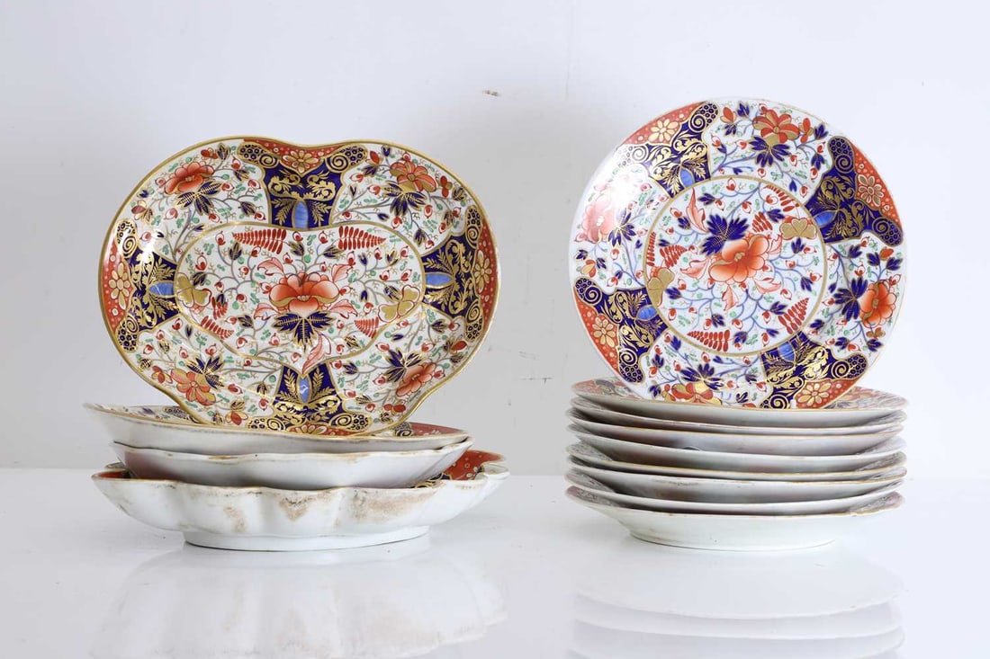 A Crown Derby breakfast service, 19th to 20th century,: A Crown Derby breakfast service, 19th to 20th century, comprising nine circular plates, a pair of cordiform dishes, a quatrefoil dish and a lobed dish, each richly decorated in the traditional Imari