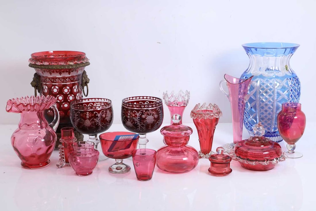 A collection of cranberry glass items, late 19th and 20th century,: A collection of cranberry glass items, late 19th and 20th century, fourteen various pieces, a blue and clear Waterford vase, labelled, a ruby flash cut and metal mounted vase and a pair of goblets 