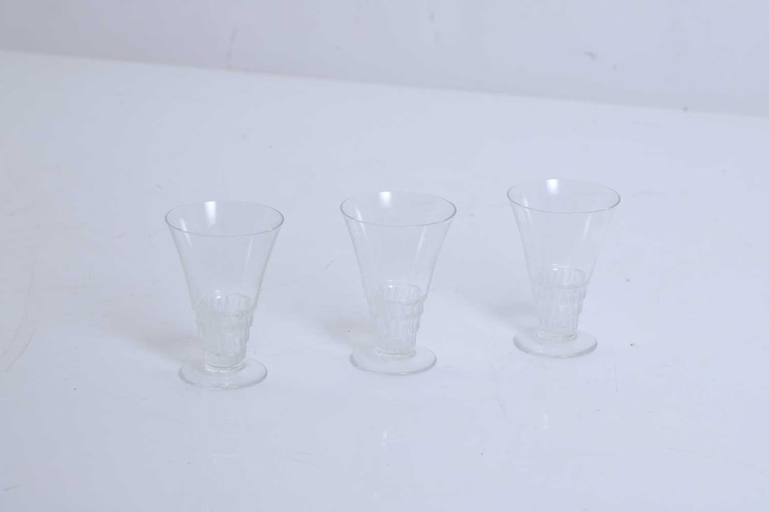 Three Lalique drinking glasses, 20th century and later,: Three Lalique drinking glasses, 20th century and later, with art deco style bases, inscribed to the bases, together with a pair of Venetian cocktail glasses, with blue glass bowls and gold leave