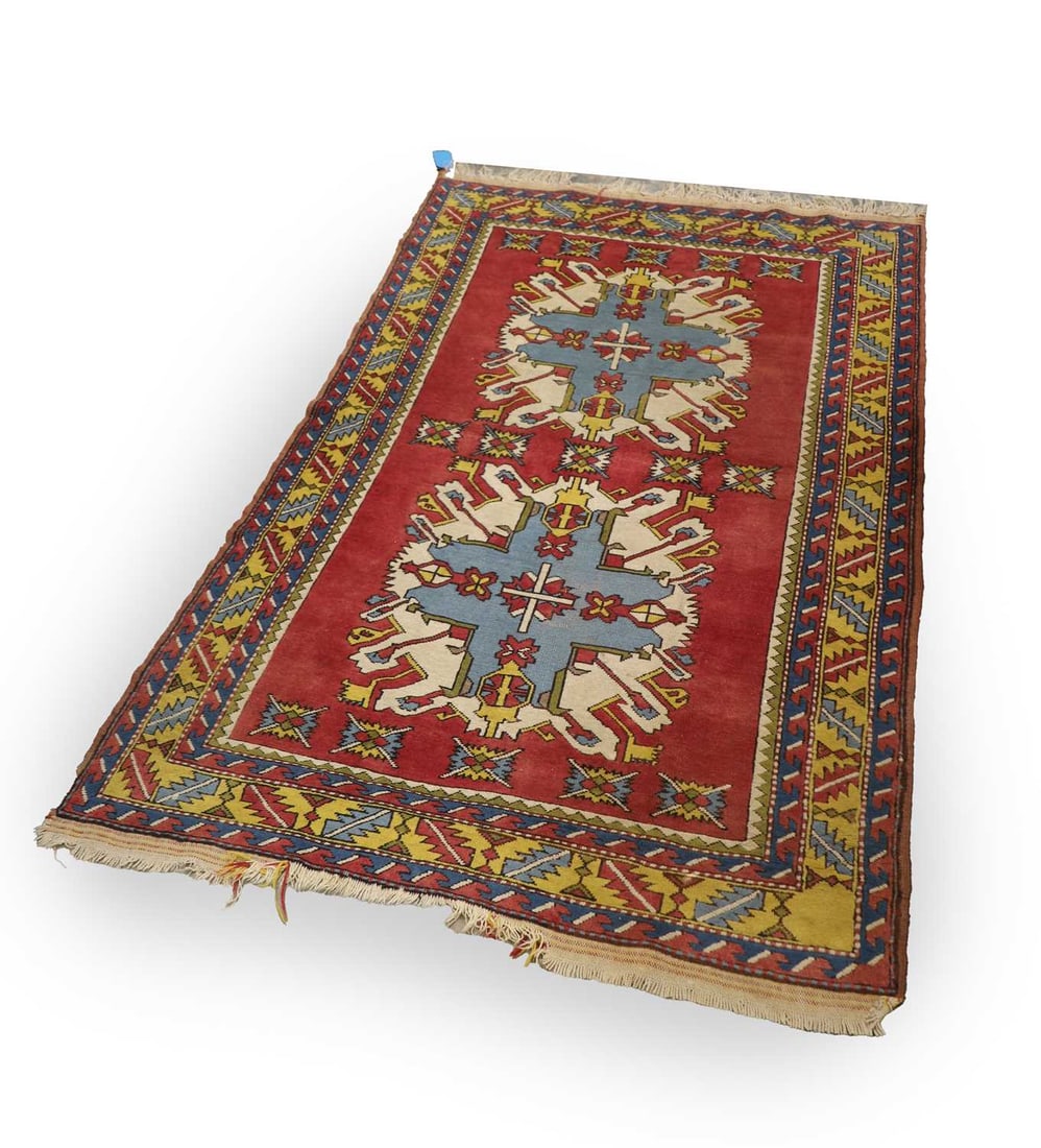An Eagle Kazak style rug, modern,: An Eagle Kazak style rug, modern, the red field with two large stepped polychrome medallions, surrounded by stylised geometric motifs, within a polychrome stepped and zigzag border, fringed at both