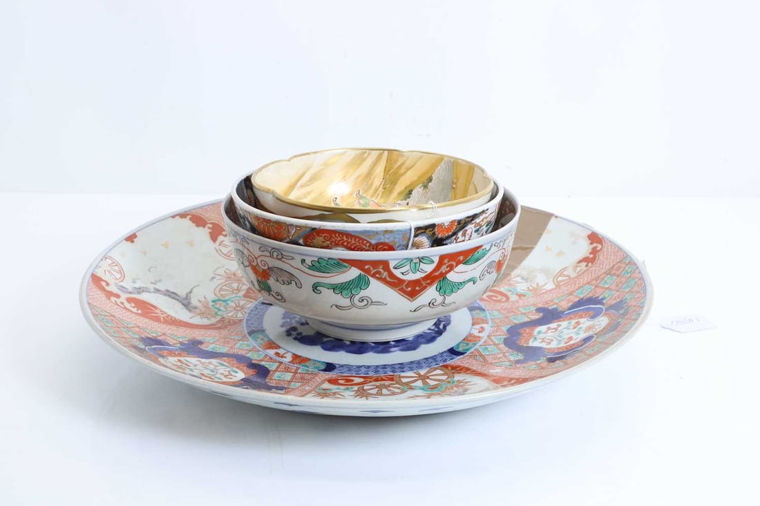 An Imari charger, 19th/20th century,: An Imari charger, 19th/20th century, with six section rim, and rock garden to the center, damaged, together with two Imari bowls with floral decoration and a Japanese satsuma bowl, with fluted and