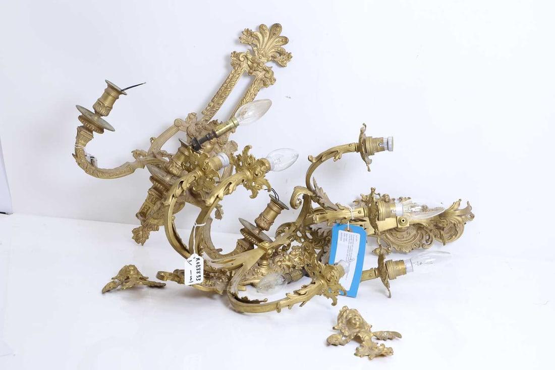 A composed set Louis XV-style gilt-metal wall appliques or sconces, late 19th/early 20th century,: A composed set Louis XV-style gilt-metal wall appliques or sconces, late 19th/early 20th century, in the Rococo taste each with scrolls, foliage and applied masks, issuing three branches,