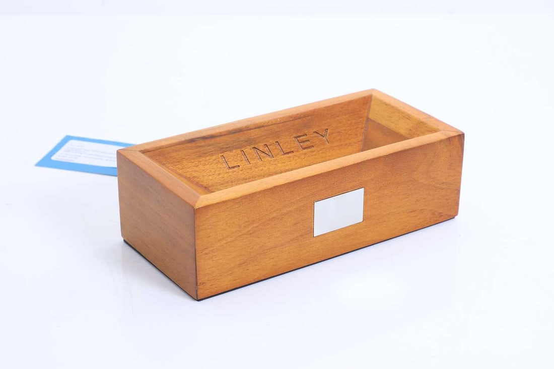 A David Linley 'brick' oak doorstep or paperweight, of recent manufacture,: A David Linley 'brick' oak doorstep or paperweight, of recent manufacture, With a white metal plaque inscribed 'LINLEY' 21.5cm wide, 10.1cm deep, 6.5cm high