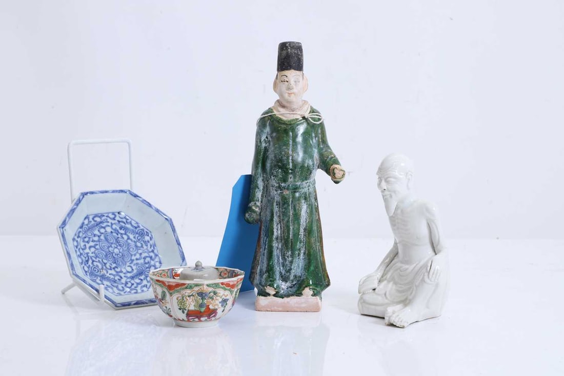 A collection of Chinese porcelain, 20th century,: A collection of Chinese porcelain, 20th century, including a green glazed Ming dynasty figure, a blue and white octagonal saucer, a white-glazed seated luohan, and a blue and white jarlet, 