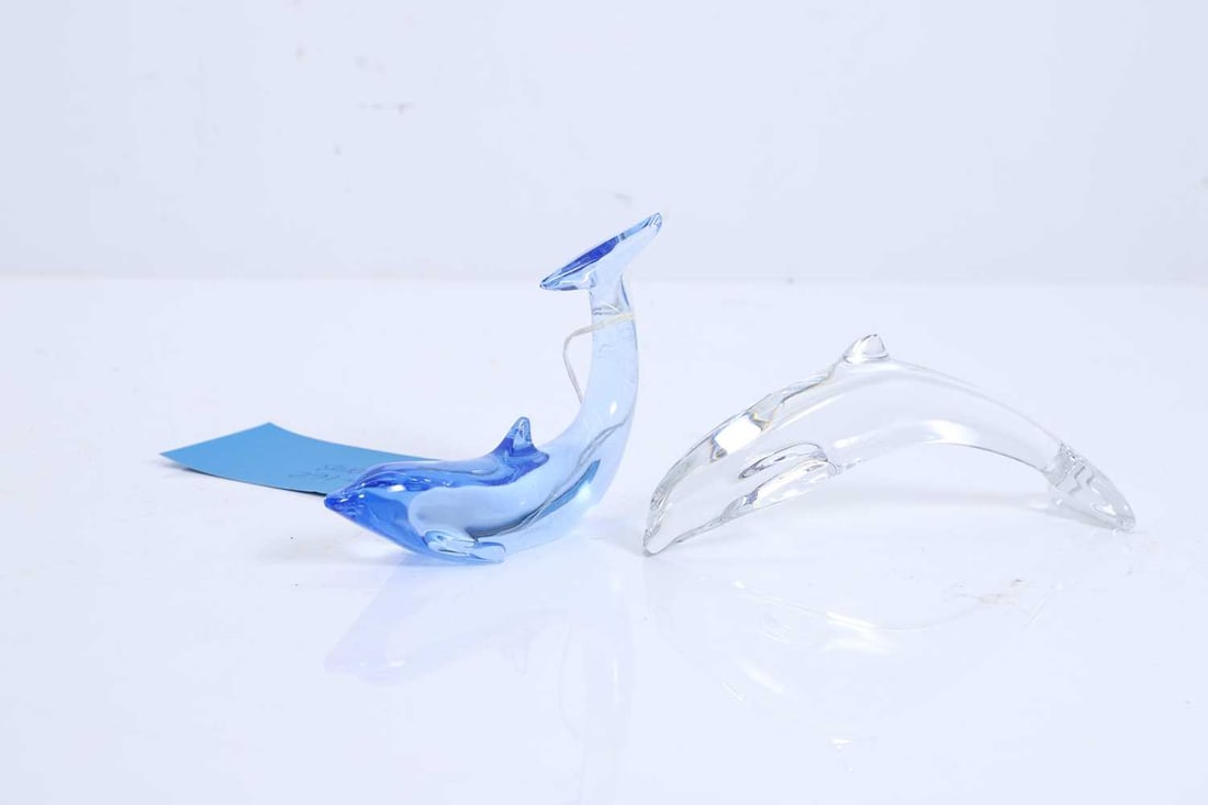 Two Baccarat glass dolphins, 20th century,: Two Baccarat glass dolphins, 20th century, both leaping, one clear and another blue, with marks to the bases 13cm long and 15.5cm long 2