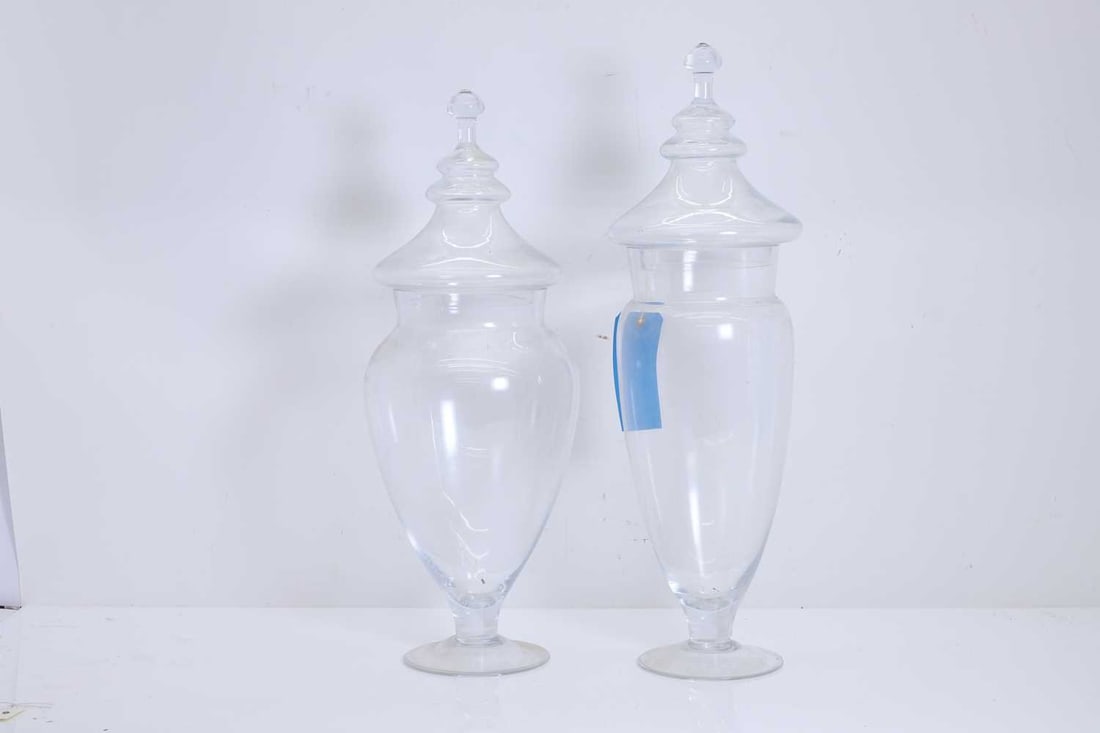 A pair of decanters, of modern manufacture,: A pair of decanters, of modern manufacture, modelled as bottles with silvered necks, and globular stoppers 11cm wide, 44cm high 4 Condition Report: The stoppers with marks and scratches. The