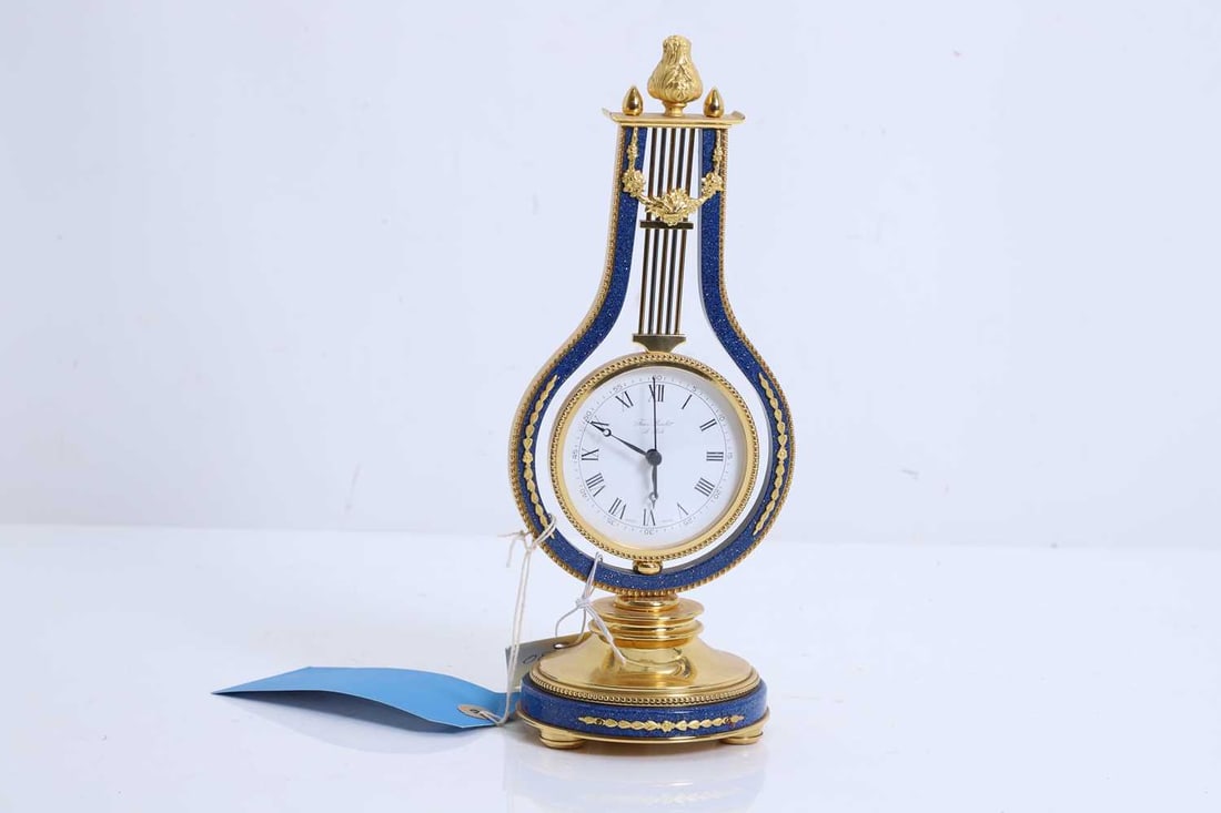 Jean Roulet mantel clock,: Jean Roulet mantel clock, shaped like a lyre, the dial with a Roman chapter ring and inscribed 'Jean Roulet Le Locle', the back marked ' SWISS 2447' 11cm wide, 26.5cm high Condition Report: