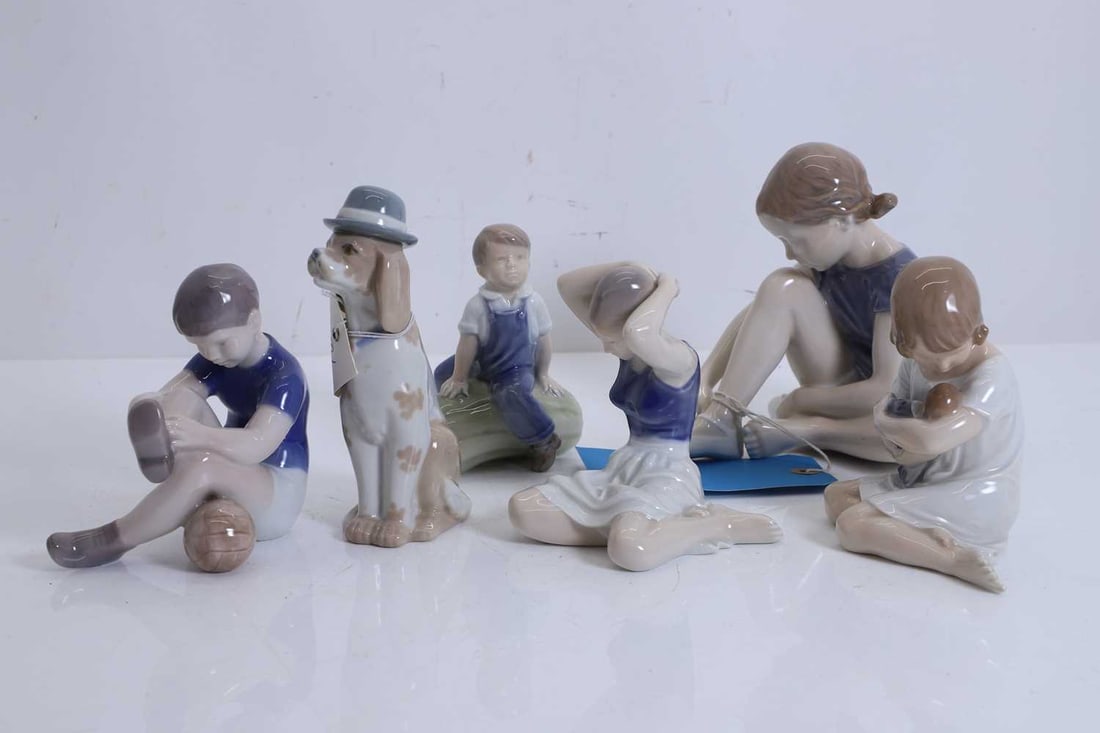 A collection of Royal Copenhagen figures,: A collection of Royal Copenhagen figures, to include a figure of a boy on a large gourd, with blue stamped mark to the base and numbered '4539', a girl seated, numbered '4642', three more Copenhagen