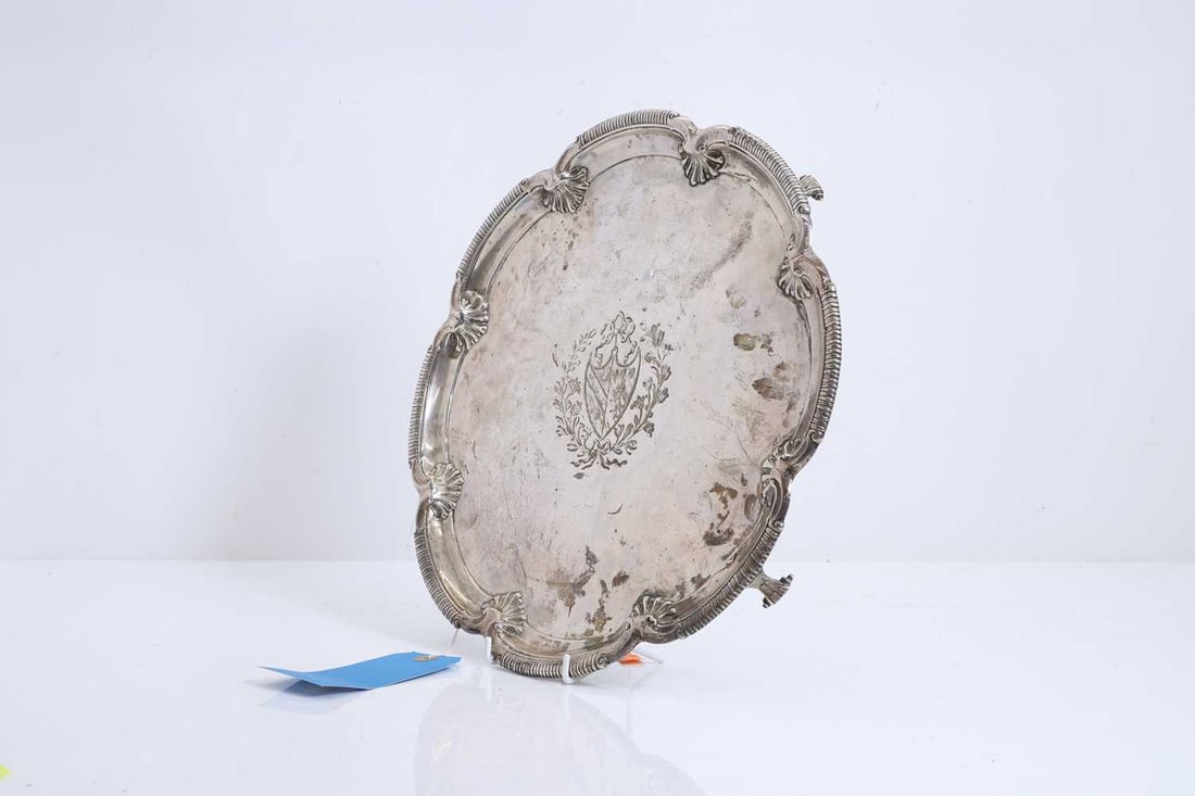 A silver-plated salver, 20th century,: A silver-plated salver, 20th century, of circular form with a gently raised and reeded rim, the rim with engraved initials 'LHA' 33cm diameter Condition Report: With tarnishing and surface
