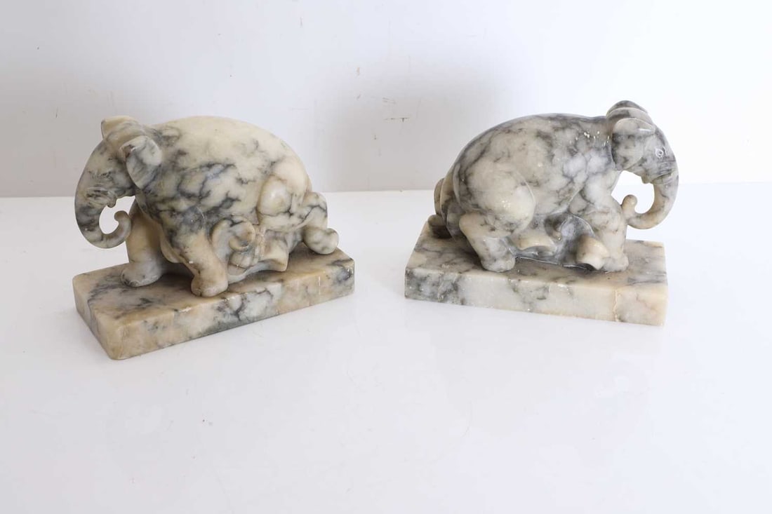 A pair of veined marble elephant bookends, 20th century, - 2