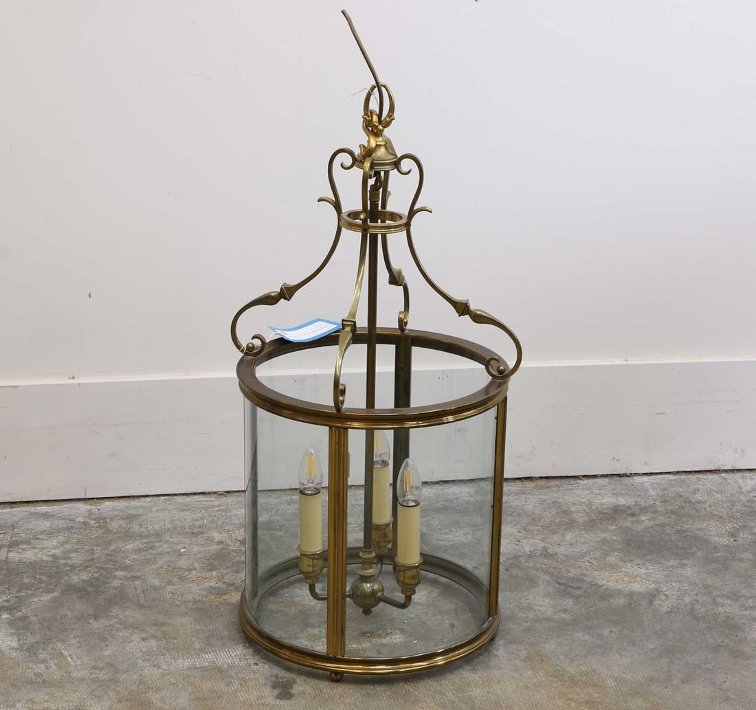 A Regency style hall lantern,: A Regency style hall lantern, with scrolled supports terminating in a three-branch light, with glazed case 42cm wide, 82cm high