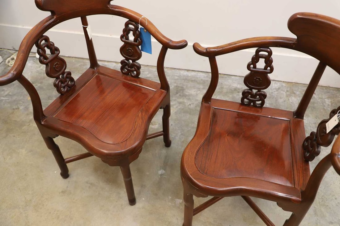A pair of Chinese hardwood horseshoe back corner chairs, 20th century, - 2