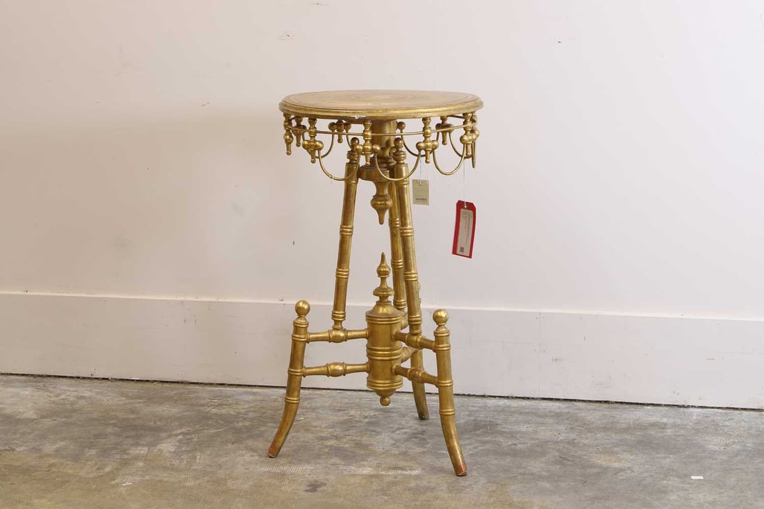 A giltwood occasional table, 20th century,: A giltwood occasional table, 20th century, on turned tripod supports with a circular rotating top 42cm diameter, 76cm high Condition Report: Fading to the gilding. Some lines of the aprons have