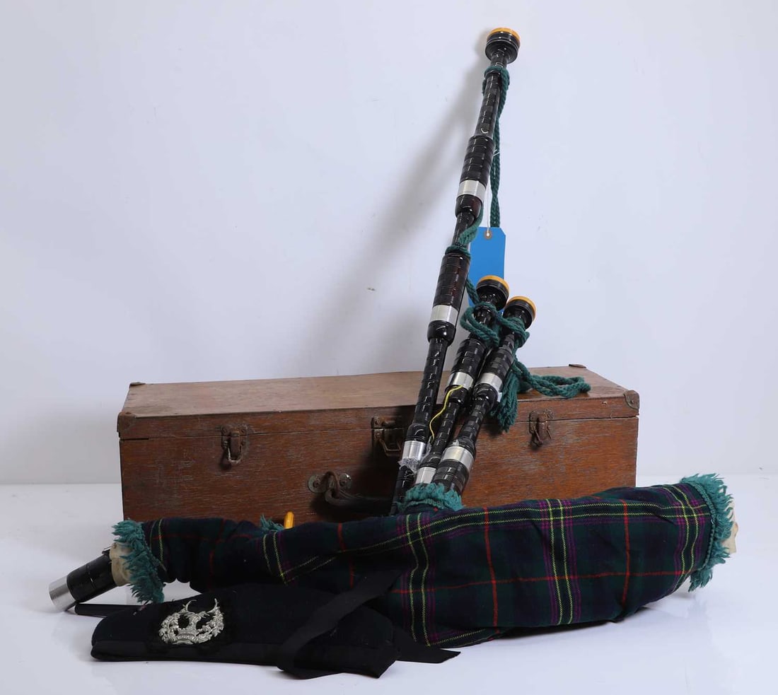 A set of bagpipes, 20th century,: A set of bagpipes, 20th century, stamped 'McLeod, Forfar', with turned ebony pipes, ivorine and metal mounts, the bag with Kennedy modern tartan, a hat with Gordon Highlander badge, Logan's