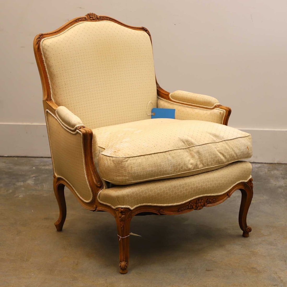 A French walnut fauteuil, 20th century, (1 of 2)