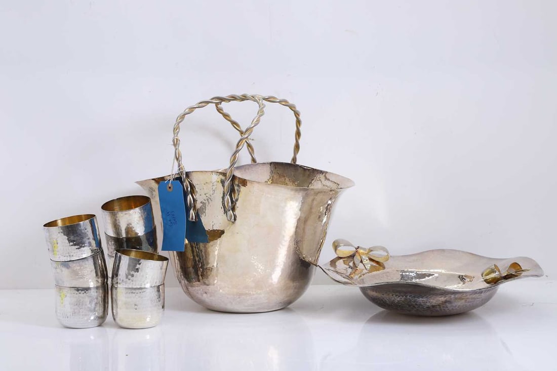 A plannished white metal champagne basket,: A plannished white metal champagne basket, the circular bowl with everted rim, with twisted carrying handles, stamped to the base, together with a fluted dish, by the same maker, with bow handles,