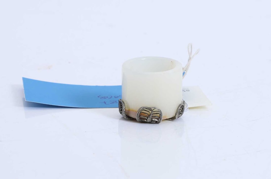 A Chinese hardstone waterpot,: A Chinese hardstone waterpot, of cylindrical form, mounted with a silvered filigree base 4.5cm diameter 2 Condition Report: Some natural flaws to the stone. The filagree bent out of shape in