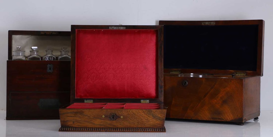 A mahogany travelling medicine box, 20th century,: A mahogany travelling medicine box, 20th century, of narrow form with brass handles and escutcheons, the lid opening to reveal an array of glass bottles with stoppers, together with a mahogany tea