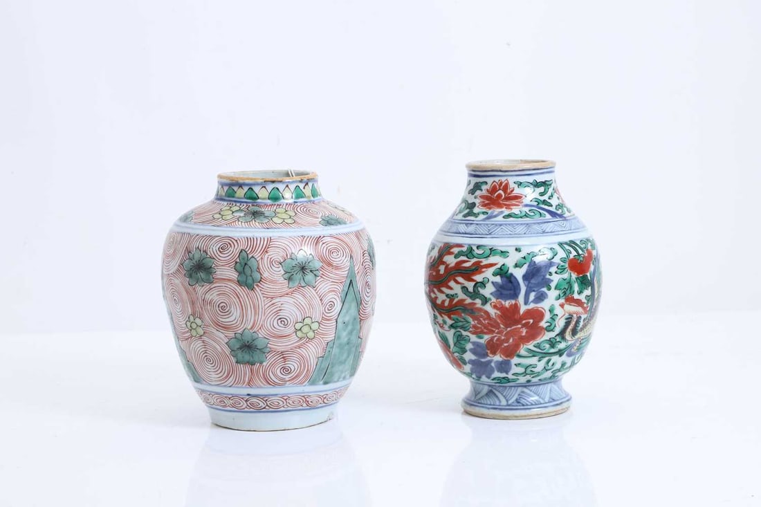 A Chinese wucai jar, Shunzhi (1644-1661),: A Chinese wucai jar, Shunzhi (1644-1661), painted with concentric circles, flowers and rockery, together with another Chinese wucai jar, Kangxi (1662-1722), restored, painted with two phoenixes,