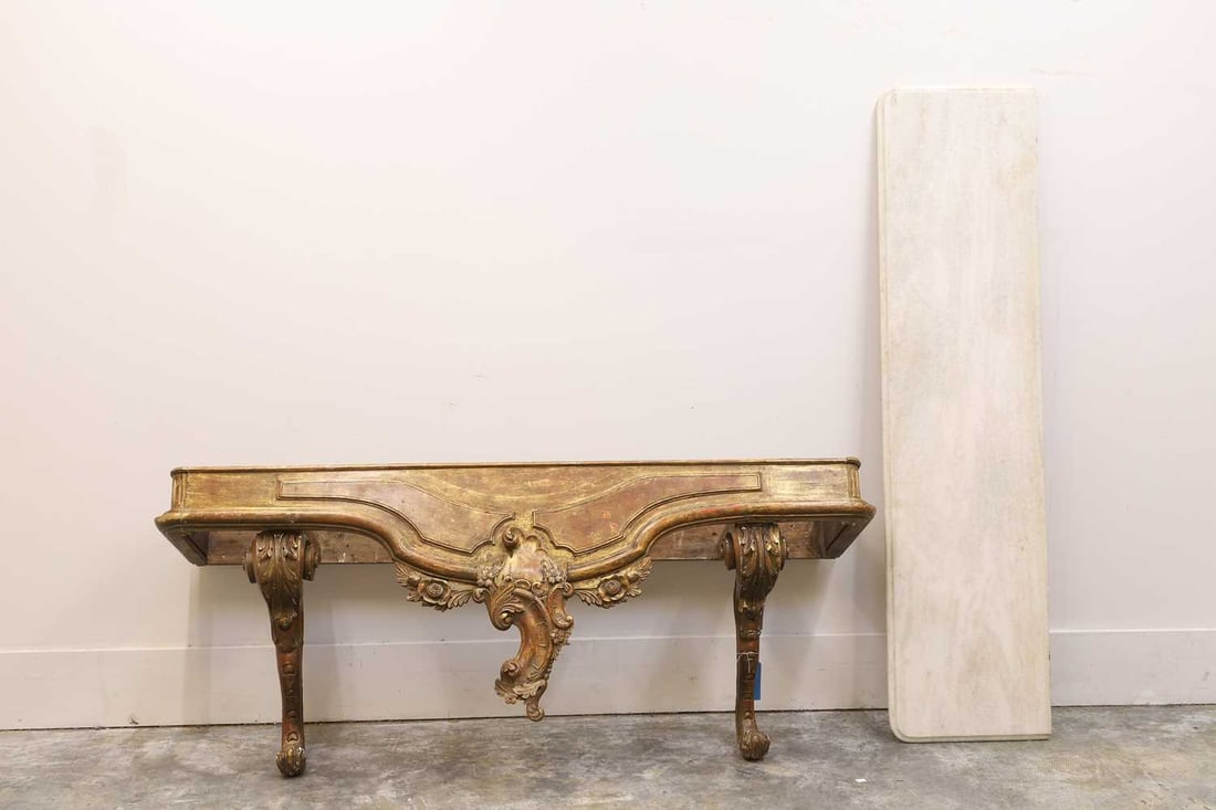 A gilt and marble console table, 19th century,: A gilt and marble console table, 19th century, with a white veined marble top, and carved foliate base with scrolling supports 174cm wide, 44cm deep, 71cm high2Condition Report: Originally made from