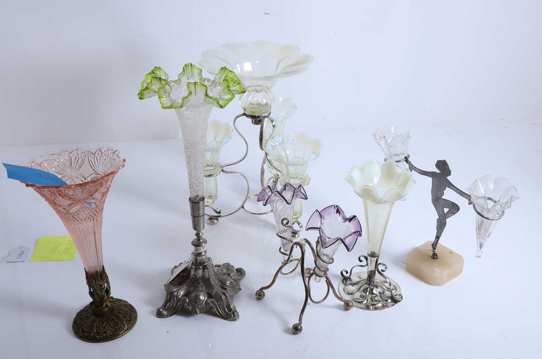 A collection of epergnes, 20th century and later,: A collection of epergnes, 20th century and later, to include a crystalised glass example, a fluted purple-tipped example, a light cranberry glass example, uranium glass, etc. The largest, 38cm high
