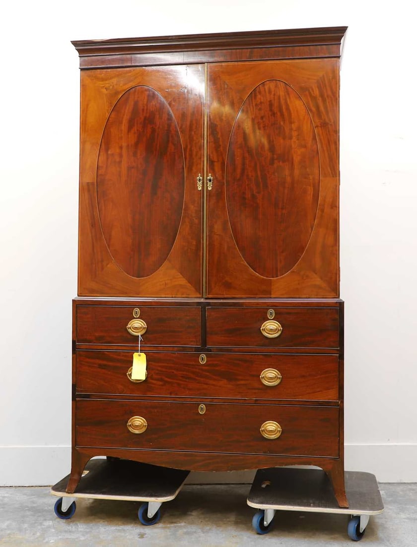 A George III mahogany linen press, late 18th century,: A George III mahogany linen press, late 18th century, converted with a hanging rail and hooks, linen-lined, with a base drawer, raised on splayed supports 122cm wide, 57cm deep, 205cm high 2 