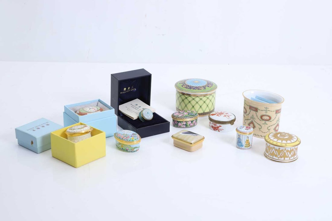 A collection of Halcyon Days enamel pill boxes, of modern manufacture,: A collection of Halcyon Days enamel pill boxes, of modern manufacture, to include 'A Year to Remember', 'Behind Every Successful Woman...', 'Roger Bannister', 'Friendship never ends', etc. A Year