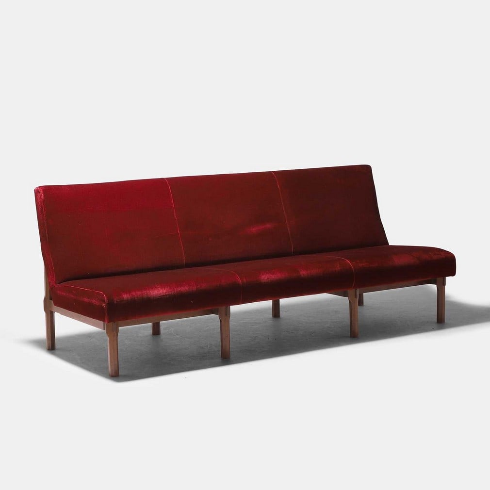 Ico Parisi (Italian, 1916-1996), a model '869' sofa,: Ico Parisi (Italian, 1916-1996), a model '869' sofa, 1960s, likely manufactured by Cassina, walnut with burgundy fabric upholstery (200cm wide, 80cm deep, 81cm high, 41cm to seat) Provenance