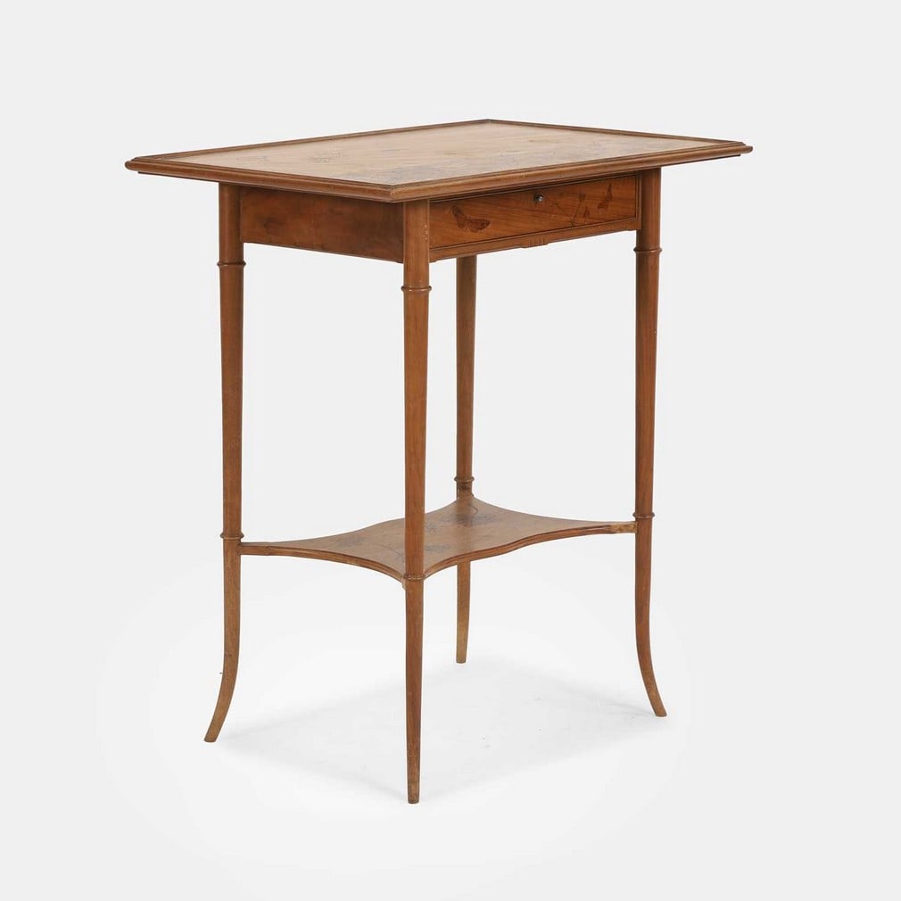 Louis Majorelle (French, 1859-1926), a beech side table,: Louis Majorelle (French, 1859-1926), a beech side table, circa 1900, the rectangular top with inlaid marquetry butterflies amongst flora and fauna, with a single drawer over an inlaid lower tier, rais