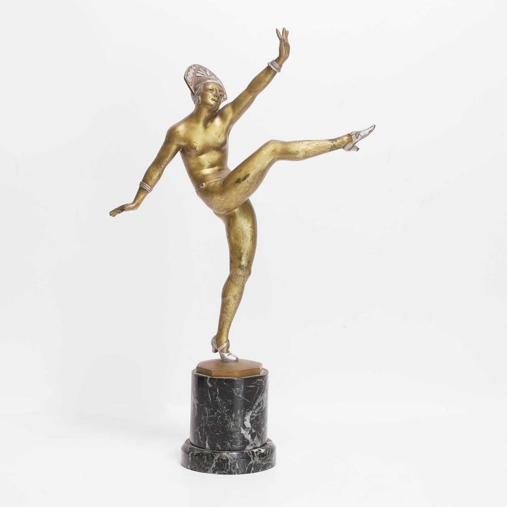 ▲ Jean Pierre Morante (French, 1882-1960), 'High Kicker',: ▲ Jean Pierre Morante (French, 1882-1960), 'High Kicker', circa 1920-30, an Art Deco bronze and cold-painted dancer, signed 'Morante', on a cylindrical marble plinth (25cm wide, 9.5cm diameter,