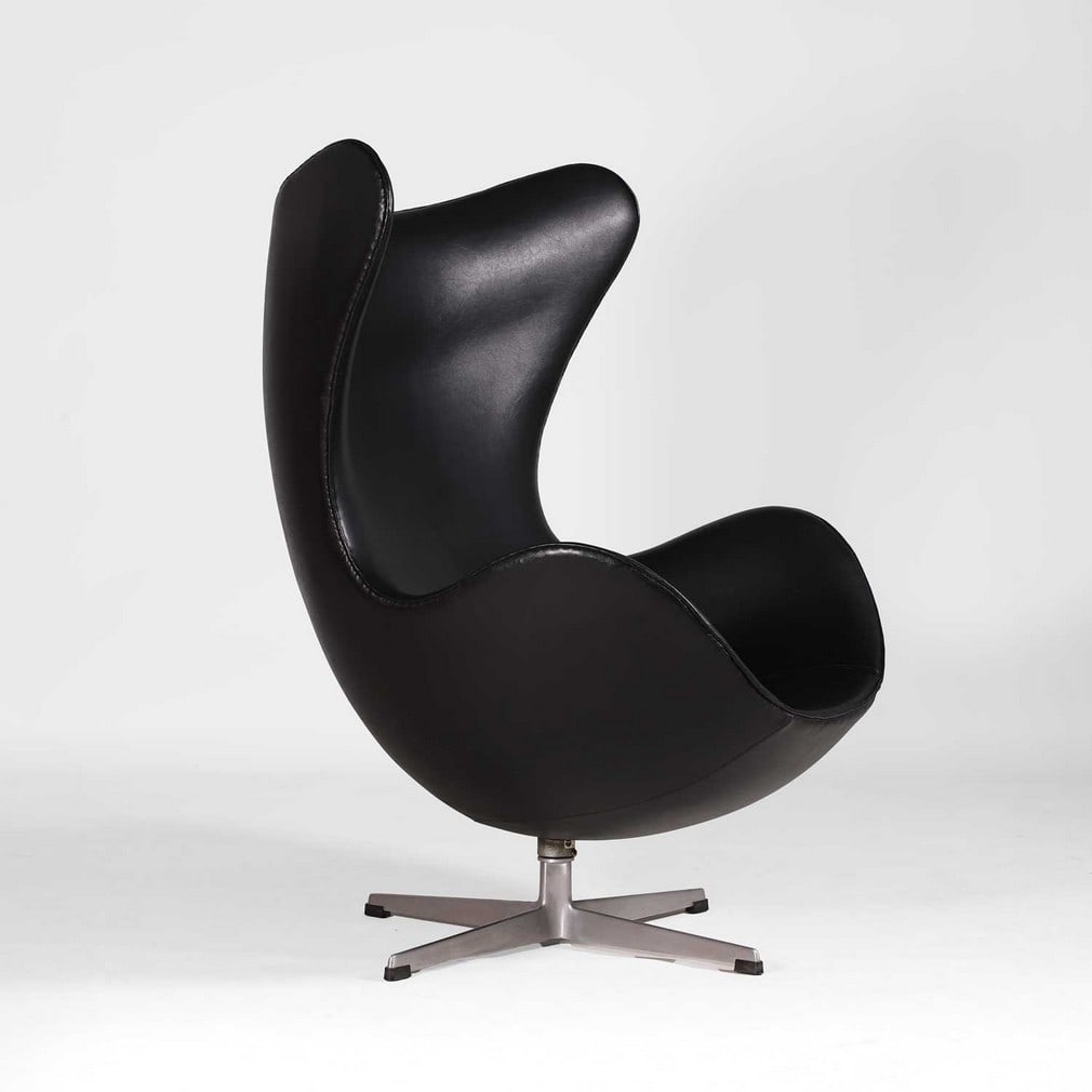 Arne Jacobsen (Danish, 1902-1971) for Fritz Hansen, an early 'Egg' chair,: Arne Jacobsen (Danish, 1902-1971) for Fritz Hansen, an early 'Egg' chair, designed in 1958 and manufactured in December 1963, black leather on a revolving stand, with manufacturer's applied label to t