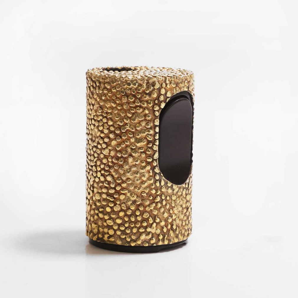 ▲ Stuart Devlin (Australian-British, 1931-2018), a silver-gilt table lighter,: ▲ Stuart Devlin (Australian-British, 1931-2018), a silver-gilt table lighter, circa 1970s, of cylindrical form, the outer case decorated with a textured pattern, with a black plastic push button