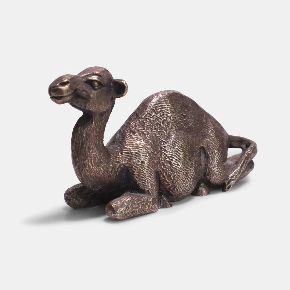▲ Stuart Devlin (Australian-British, 1931-2018), a silver-gilt paperweight,: ▲ Stuart Devlin (Australian-British, 1931-2018), a silver-gilt paperweight, London, 1979, modelled as a seated camel (6cm wide, 2.5cm deep, 3.5cm high; 2.5ozt) Provenance: The David Rapley Colle