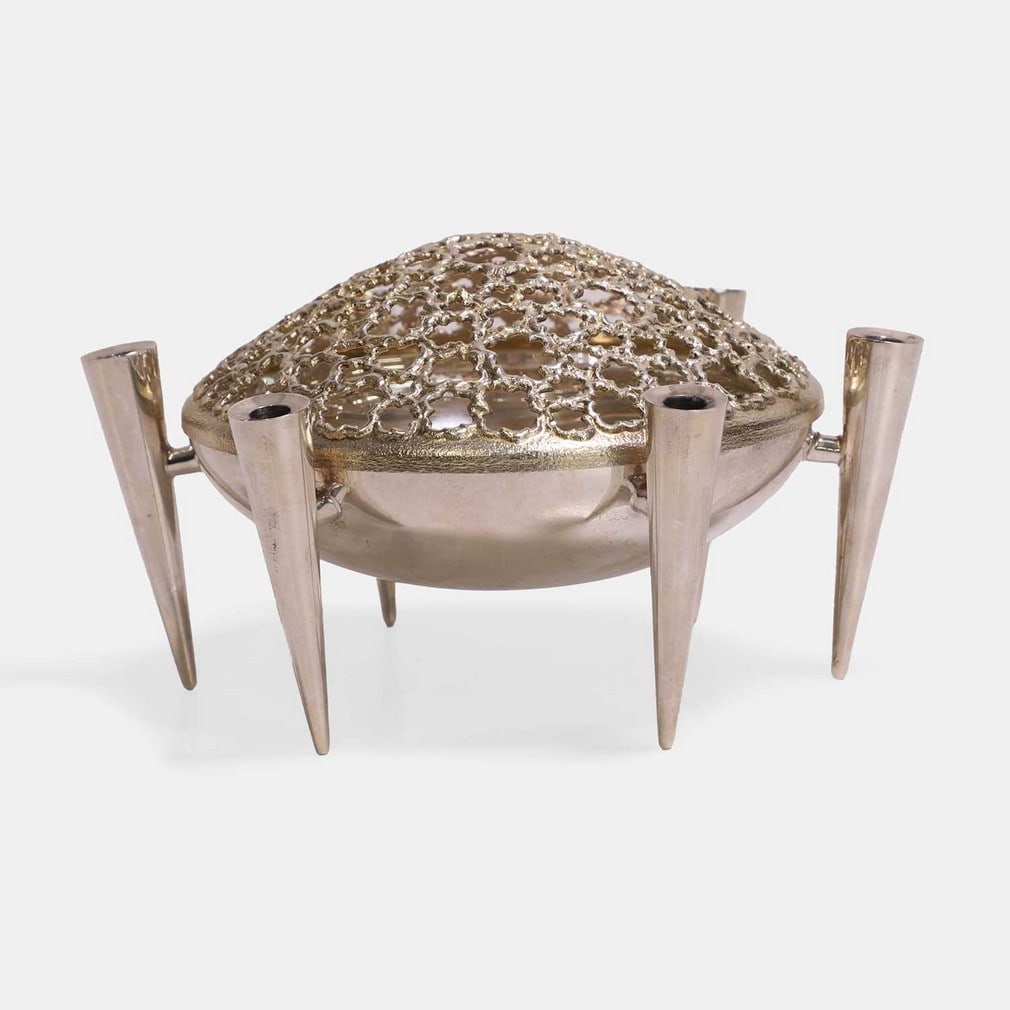 ▲ Stuart Devlin (Australian-British, 1931-2018), a silver and silver-gilt flower frog bowl,: ▲ Stuart Devlin (Australian-British, 1931-2018), a silver and silver-gilt flower frog bowl, London, 1976, the polished silver bowl bordered and raised by six conical candleholders, with a pierce