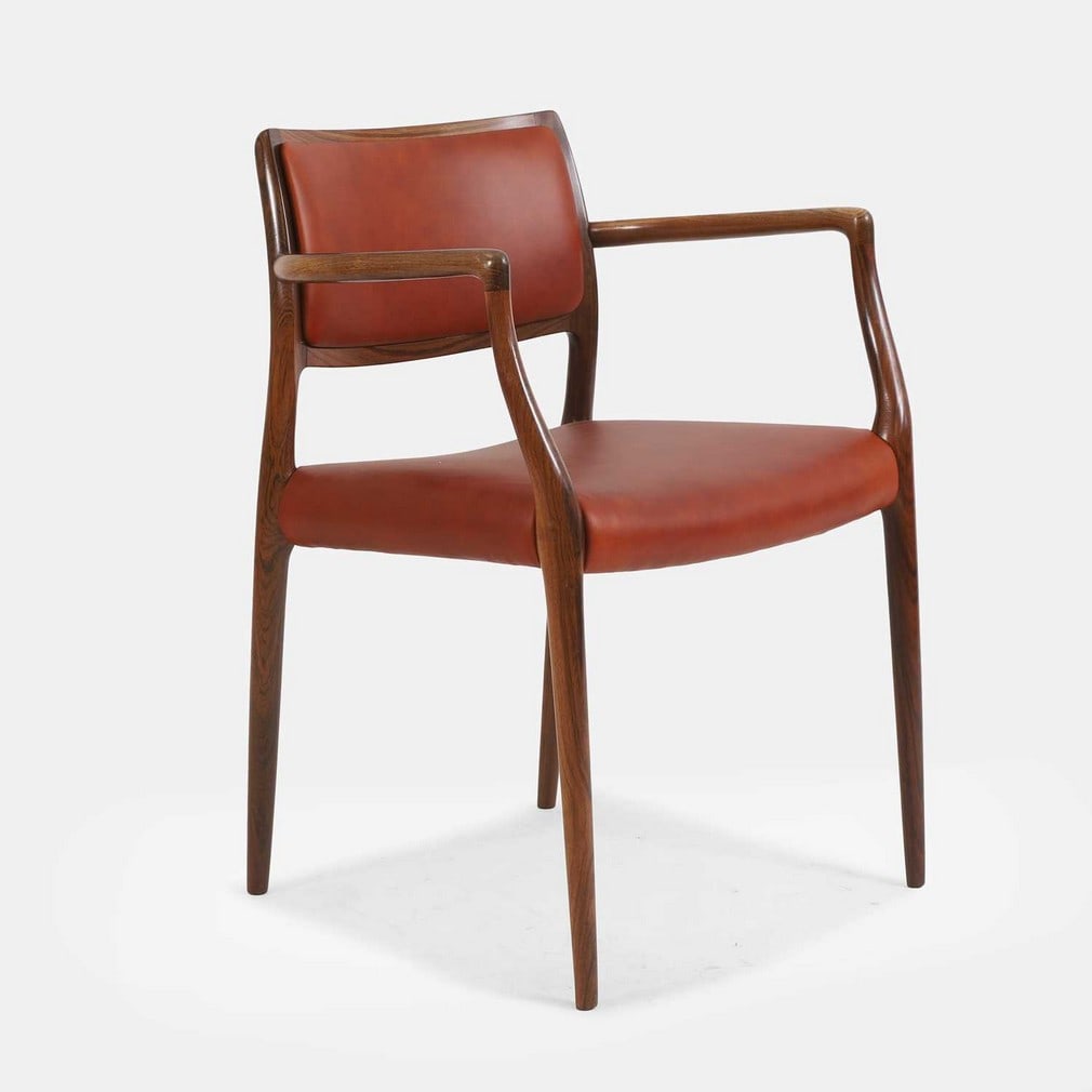 § ▲ Niels Otto Møller (Danish, 1920-1982) for J L Møllers, a rosewood model: § ▲ Niels Otto Møller (Danish, 1920-1982) for J L Møllers, a rosewood model '65' chair, originally designed in 1968, the rosewood frame raised on four tapering legs, with a later