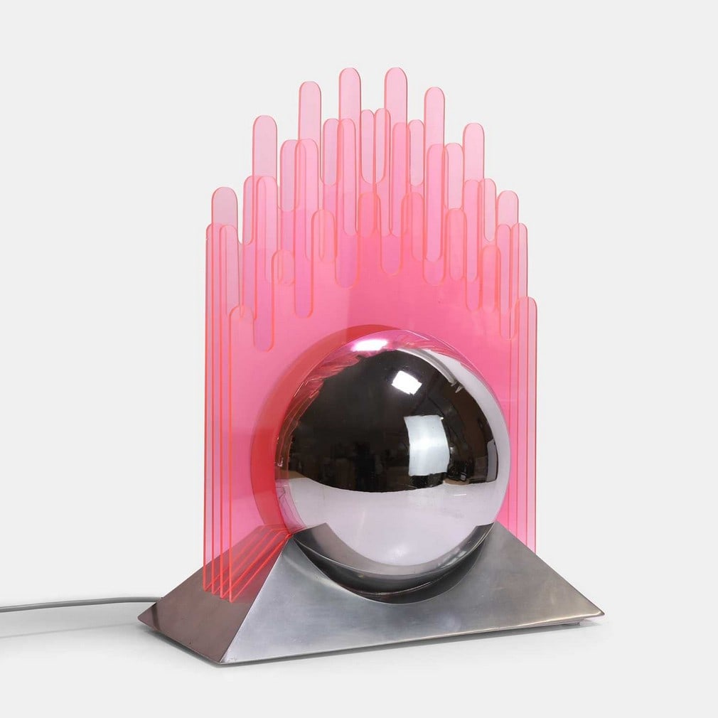 Gae Aulenti (Italian, 1927-2012), a table lamp,: Gae Aulenti (Italian, 1927-2012), a table lamp, circa 1970, pink acrylic, chrome-plated steel and aluminium, probably manufactured for New Lamp (40.5cm wide, 20cm deep, 52cm high) Footnote: Charlotte
